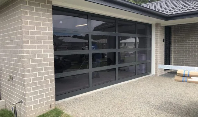 Sectional garage door with aluminium window panels