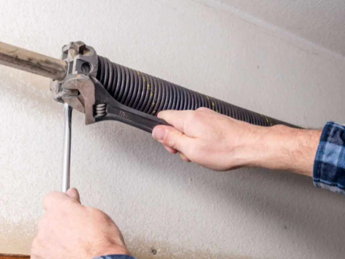 Garage door spring assembly above a residential garage door