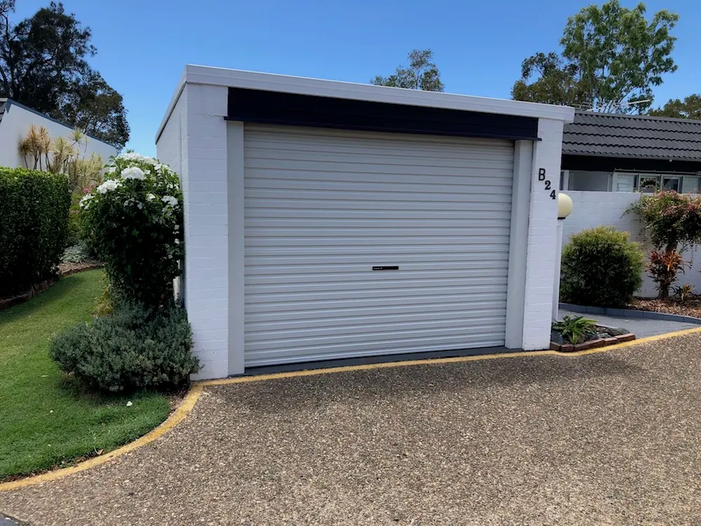 White roller door fitted to a painted brick garage in a Brisbane unit complex
