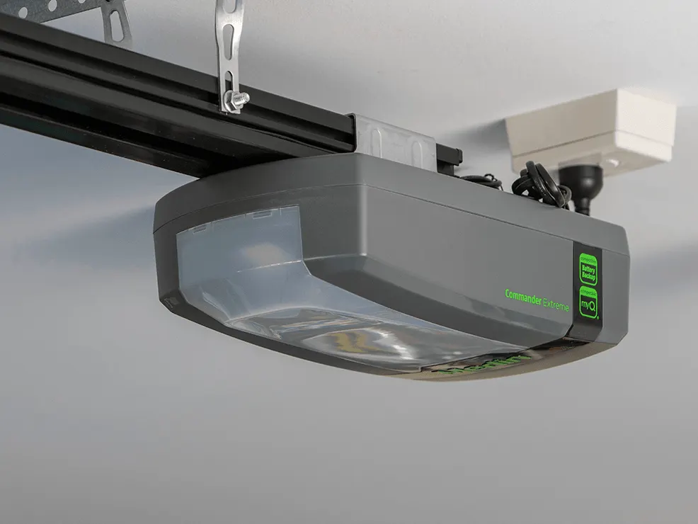 Garage door opener mounted on its ceiling rail, where the brand label sits