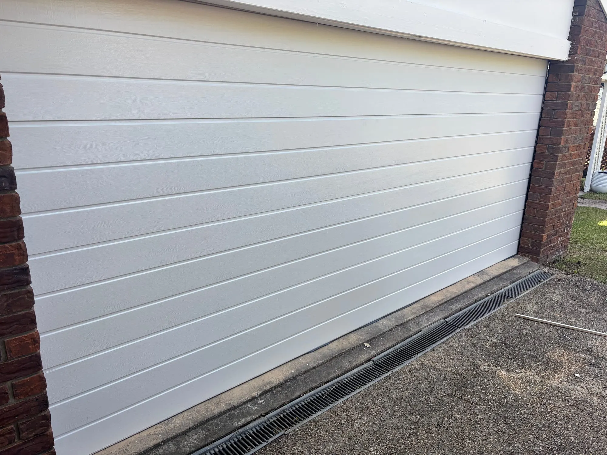 Edge of a closed sectional garage door where identification stickers are usually applied